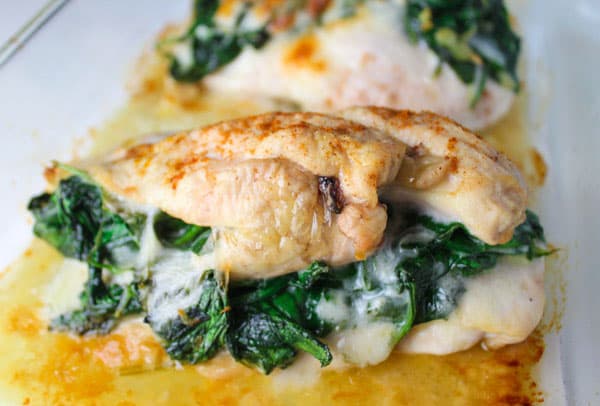 These Baked Spinach Provolone Chicken Breasts are Low Carb and so delicious. So simple to make, just butterfly the chicken breasts, add spinach, and provolone cheese. Then just wrap it and bake it! | Tastefulventure.com