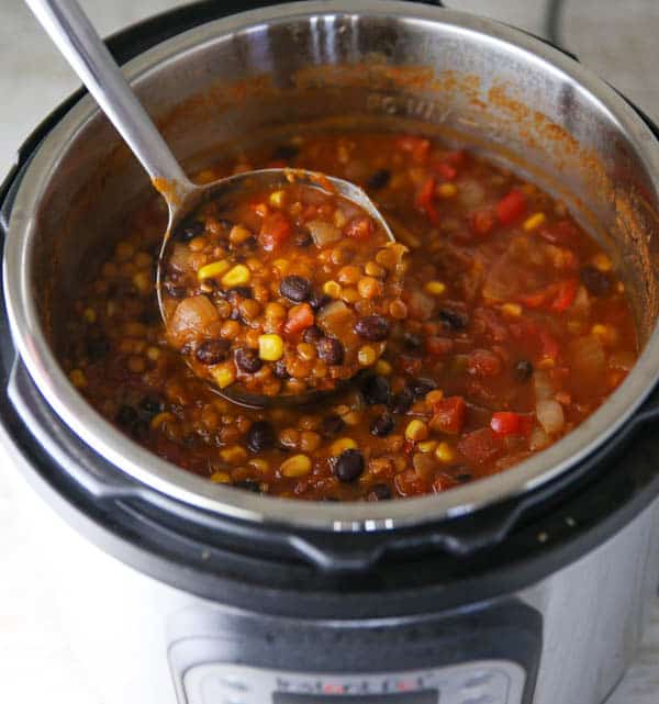 Lentil and Black Bean Chili being scooped out in the Instant Pot