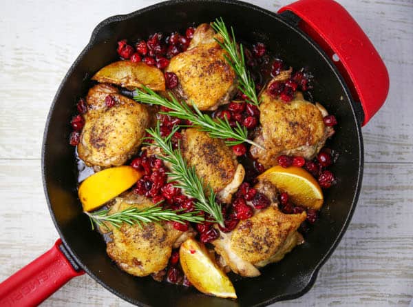 Cranberry Orange Chicken Thighs with Rosemary in a skillet