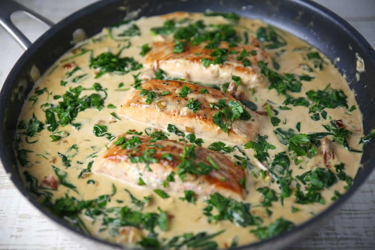 Tuscan Salmon being cooked in a skillet